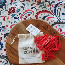 Load image into Gallery viewer, Sockclips keeping socks together in the wash 10 pack red clips on wooden board