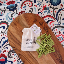 Load image into Gallery viewer, Sockclips keeping socks together in the wash 10 pack green clips on wooden board